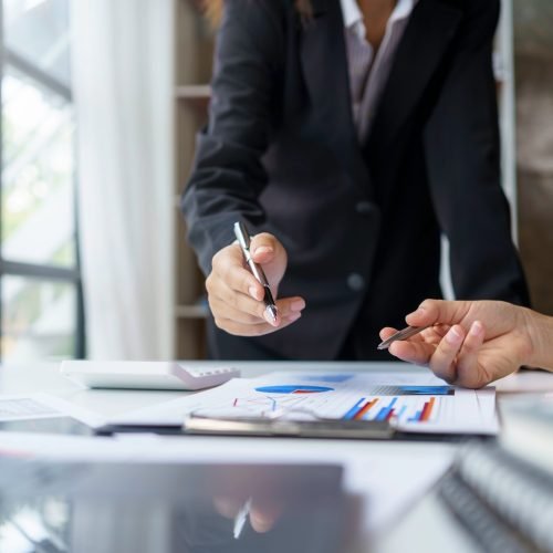 Business people analyzes, graphs and charts to examine and analyze company finances, revenues